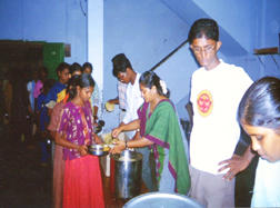 KIDS GETTING CURD RICE IN A QUE