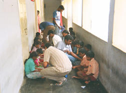 DISTRIBUTING SWEETS AT BLIND SCHOOL